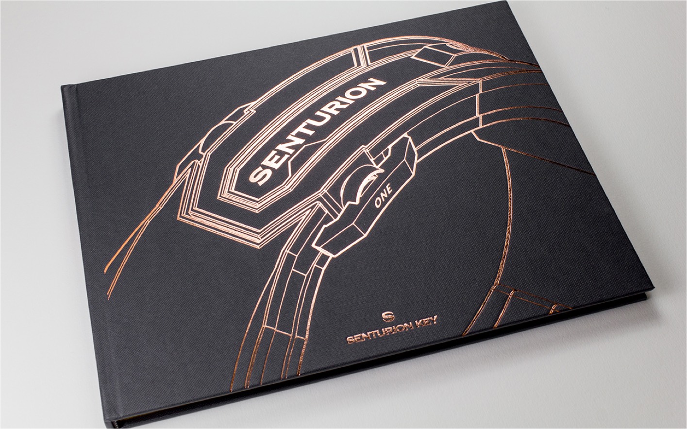 Photo of spine of Senturion print brochure closed with foil stamped logo